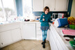 © Cavan Images - Girl in her kitchen looks toward camera annoyed