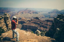 Man Photographing Sunset In Grand Canyon