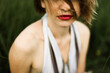 © Cavan Images - Portrait of beautiful woman in dress relaxing on grassy field