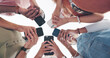 © Nina/peopleimages.com - Hands, phone and communication with friends standing in a huddle or circle from below for networking. Social media, mobile and 5g with a man and woman friend group connected to the internet together