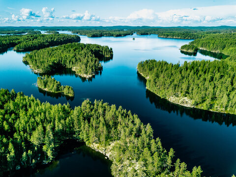 aerial finland landscape. aerial view of blue lakes with rock islands and green woods