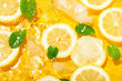© Atlas - Lemon slices, mint and ice pieces in water