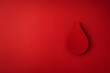 World donor day concept with paper red drop on white background