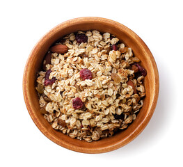 Wall Mural - Granola with nuts and raisins in a wooden plate on a white background. Top view