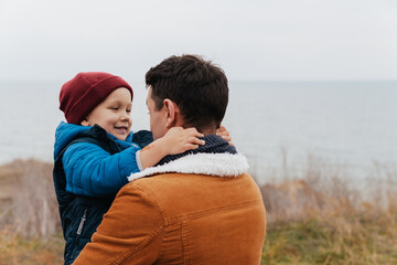 Wall Mural - Father and his cute son hugging during walk in nature