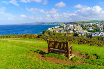 Wall Mural - Bench, the village, and the coastline, in Port Isaac