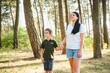 © Serhii - Cute little boy in his mother walk in nature.