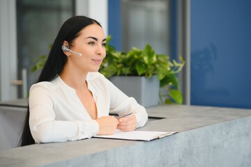 Wall Mural - Portrait of beautiful receptionist near counter in hotel