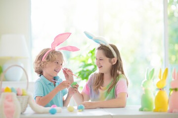 Kids on Easter egg hunt. Children dye eggs.