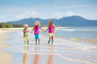 © famveldman - Kids on tropical beach. Children playing at sea.
