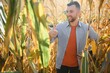 © Serhii - Farmer in field checking on corncobs