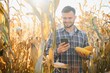 © Serhii - Farmer in field checking on corncobs