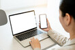 © panitan - computer screen,cell phone blank mockup.hand woman work using laptop texting mobile.white background for advertising,contact business search information on desk in cafe.marketing,design