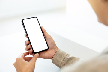 cell phone blank white screen mockup.hand holding texting using mobile on desk at office.background empty space for advertise.work people contact marketing business,technology