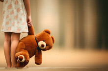 A Little Girl Holds A Teddy Bear / Teddy / Stuffed Animal In Her Hand. Background: Light Neutral Forest. The Image Symbolises Sadness, Loneliness. Space For Text.