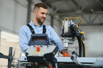 Wall Mural - Factory worker. Man working on the production line.