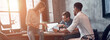 © gstockstudio - Three confident young people discussing business strategy while pointing laptop in office