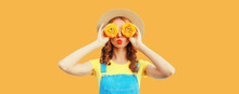 Summer Portrait Of Happy Young Woman Covering Her Eyes With Flowers As Binoculars Looking For Something Wearing Round Straw Hat, Jumpsuit On Orange Background