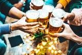 Fototapeta Londyn - Group of people drinking beer at brewery pub restaurant - Happy friends enjoying happy hour sitting at bar table - Closeup image of brew glasses - Food and beverage lifestyle concept