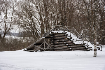 Wall Mural - old houses and household buildings made of wooden beams according to old technologies in the vicinity of Veliky Novgorod in winter