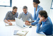 © A.B./peopleimages.com - Technology makes brainstorming more efficient. A group of business colleagues discussing work on a laptop during a boardroom meeting.