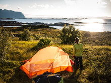 Woman Camping With Tent Near Seaside In Norway