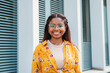 © Jose Calsina - Portrait of a hispanic happy girl with perfect white teeth smiling looking at camera santanding outdoors. Front view of young latin woman with eyeglasses. High quality photo