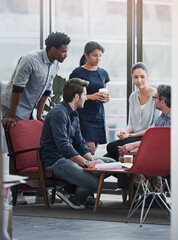Poster - This meeting is packed with creative minds. a group of coworkers in a meeting in an office.