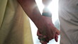 © Marco - Close up of senior hands together with sunlight flare in the background. Beautiful romantic moment between two older married couple outdoors