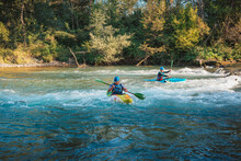 Whitewater Kayaker Paddling On The Waters Of River. Adrenaline Seekers And Nature Lovers.