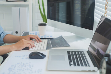 Wall Mural - programmer writing program code with two monitors programmer analysis working with software code sol