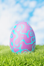 Easter Egg In The Grass In The Meadow. Pink Easter Egg In Blue Patterns. 3d Render.