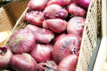 Red Or Purple Onion Lies In A Rectangular Basket For The Sale