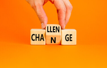 Challenge and change symbol. Concept word Challenge Change on wooden cubes. Businessman hand. Beautiful orange table orange background. Business and challenge and change concept. Copy space.