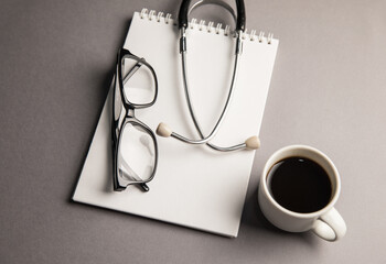 Wall Mural - Stethoscope, notebook and coffee cup