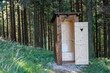 New open wooden outdoor toilet, outhouse in forest in beskid mountains.