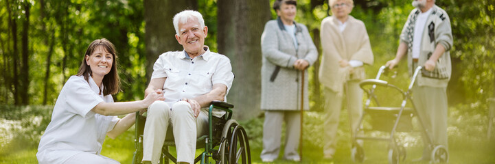 Sticker - Mature caregiver and elder man on the wheelchair