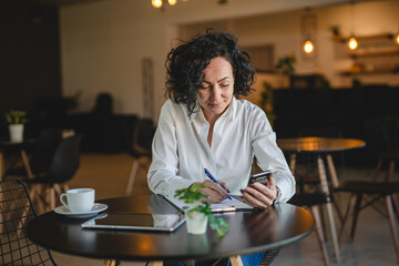 Wall Mural - One woman mature female entrepreneur use smartphone phone at work