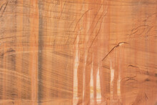 A Red Sandstone Cliff In Zion Nat. Park, Utah, USA Shows Horizontal And Diagonal Striation Layers And Vertical Streaks From Water Dripping Down The Cliff Causing Oxidization To Color The Stone Face.