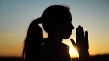 Silhouette Young Woman Praying At Sunset. Christian Prayer In Nature. Morning Prayer Of Girl Outdoors. Freedom Of Religion. Era Of Mercy, Kindness, Love. Path Of Soul To God Through Prayer.