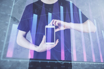 Wall Mural - Double exposure of man's hands holding and using a digital device and forex graph drawing. Financial market concept.