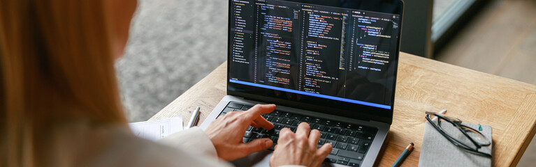 Close up of woman freelance programer working on laptop while sitting in cafe. Data done right