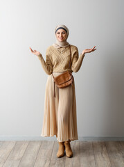 Sticker - Stylish Muslim woman in beige hijab near light wall