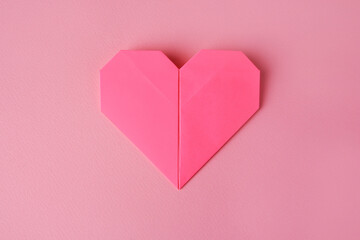 Sticker - Origami art. Paper heart on pink background, top view