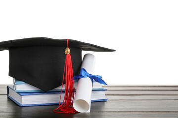 Graduation hat with diploma and books on dark wooden table against white background