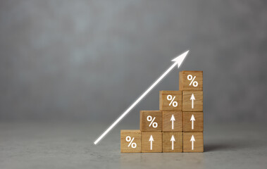 Interest rate financial and mortgage rates concept. Wooden blocks with icon percentage and arrow pointing up. The economy is improving. Increase interest rate investment dividend from business growth.