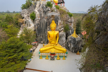 The big gold Buddha statue at Tham Champathong monastery, Ratchaburi, Thailand