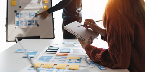 Team ux designer creative graphic planning application development a prototype smartphone layout