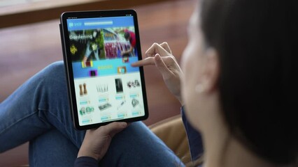 Person holding tablet browsing online shop. Woman shopping household products in the internet with modern digital device