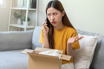 Angry bad, complaint asian young woman opening carton box, received online shopping parcel wrong product order from retail store, using mobile phone talking with support shop want to return package.